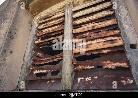Old corroded rusted window shutters Stock Photo