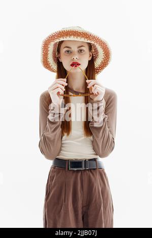 A Cute Fashion Model in a Hat Poses Holding Glasses on a White Background.  Catalog Photography for the Magazine Stock Photo - Image of dress,  hairstyle: 252285750