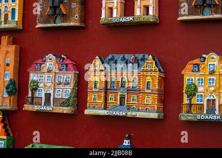 Rows of fridge magnet souvenirs from Gdansk displayed on stillage. Model houses magnets on display in Gdansk Poland travel destination concept in city market square Stock Photo