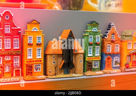 Rows of fridge magnet souvenirs from Gdansk displayed on stillage. Model houses magnets on display in Gdansk Poland travel destination concept in city market square Stock Photo