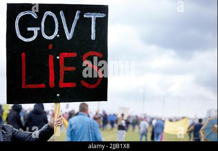 We will no longer fall for your lies. Unrecognisable demonstrators holding up signs and protesting against government corruption. Stock Photo