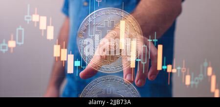 Crypto trader investor analyst , holding gold bitcoins. Checks and controls the financial database Stock Photo