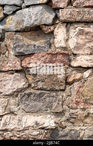 Rough textured stone wall. Grunge natural rocky texture Stock Photo