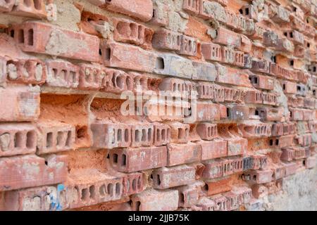Old ruined red brick wall. Destroyed brickwork. Grunge background. Selective focus Stock Photo