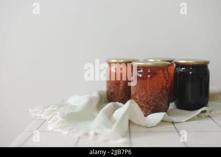 currant jam in jar on a light background in rustic style Stock Photo
