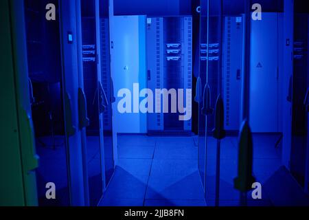 Shot of data center with multiple rows of fully operational server racks Stock Photo