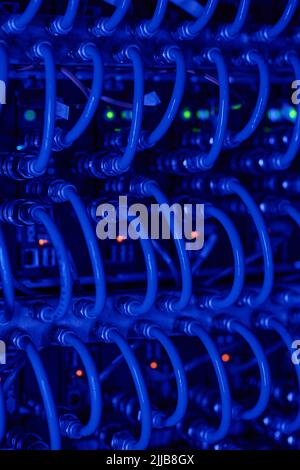 Network device front panel with cables connected in data center room Stock Photo