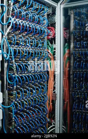 Close up view of internet equipment and cables in rack in the server room Stock Photo
