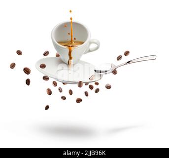 cup of coffee with coffee beans, saucer, and spoon floating on white background. Stock Photo