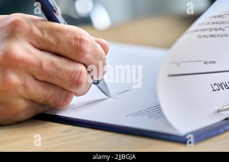Business man ceo executive putting hand signature on document, signing contract. Stock Photo