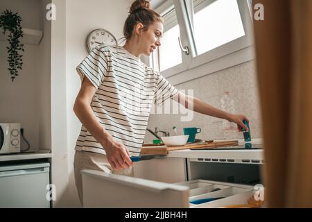 Young housewife working in her home kitchen Stock Photo