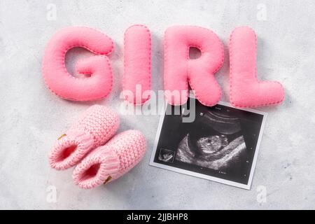 Ultrasound scan of unborn baby with letters girl Stock Photo