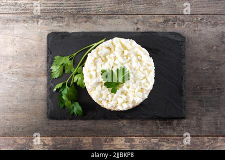 Traditional Russian layered salad Mimosa on wooden table Stock Photo
