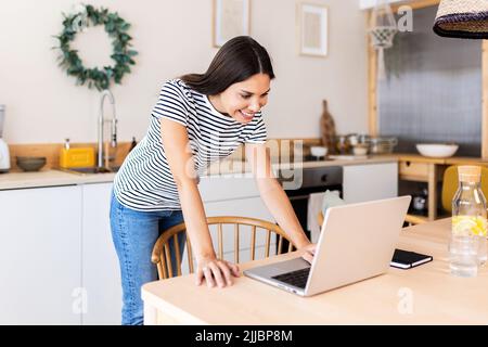 Young adult business woman working remotely from home Stock Photo