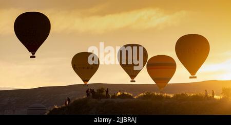 GOREME/TURKEY - June 27, 2022: hot air balloons fly at sunrise over goreme. Stock Photo