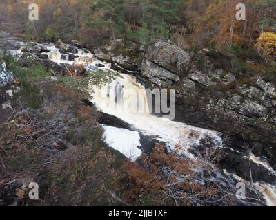 A late autumn day at Rogie Falls, on the Black Water river, near Strathpeffer. Trees in autumnal colours, & rocks surrounding the cascades. Stock Photo