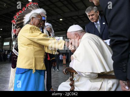 Edmonton, Canada. 24th July, 2022. Pope Francis kisses the hand of residential school survivor Elder Alma Desjarlais of the Frog Lake First Nation during his welcoming ceremony at Edmonton International Airport, AB, western Canada on July 24, 2022 for his six-day papal visit across Canada. Pope's visit to Canada is aimed at reconciliation with Indigenous people for the Catholic Church's role in residential schools. Photo by Vatican Media (EV)/ABACAPRESS.COM Credit: Abaca Press/Alamy Live News Stock Photo