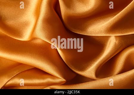 Texture of orange silk fabric, close up Stock Photo