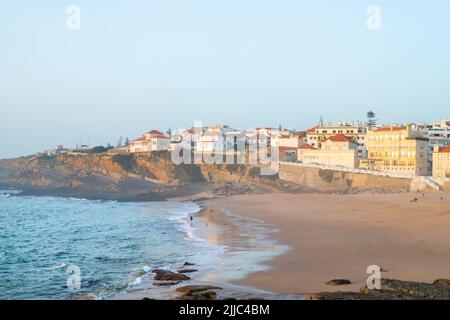 Praia das Macas Apple Beach in Colares, Portugal, on a stormy day before sunset Small city on ocean shore Stock Photo