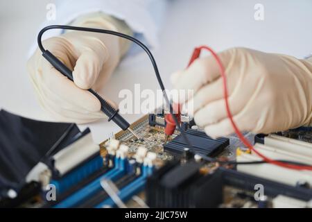 Macro shot of female engineer working with electronic parts in laboratory, copy space Stock Photo