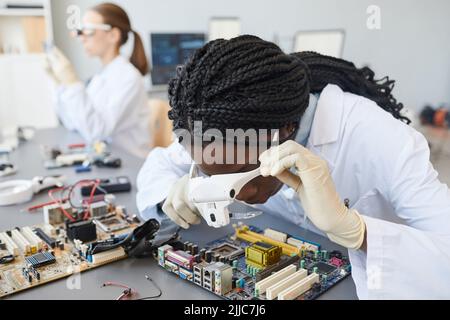 Portrait of black of female engineer inspecting computer parts in quality control lab Stock Photo