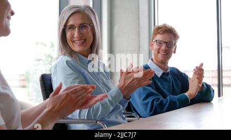 Multiracial business audience people group smiling applauding at conference. Stock Photo