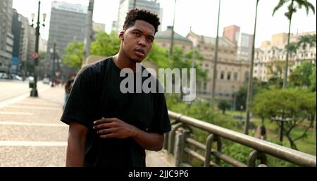 Cool young black man in downtown city. African guy standing outside Stock Photo