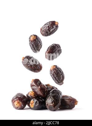 fresh dates falling isolated on white background, edible and tropical sweet fruits, closeup Stock Photo