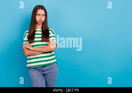 Photo of sad young lady look promo wear t-shirt jeans isolated on blue color background Stock Photo