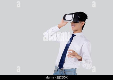 Experience of young asian businessman wearing VR Headset with excited isolated on white background, metaverse or virtual reality tech, innovation of f Stock Photo