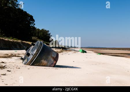 Black signaling beacon aground on the beach, Kiyu, San José, Uruguay. Another green signaling beacon can be seen in the background Stock Photo
