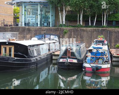 A view of three contrasting canal boats moored at Limehouse Marina in east London Stock Photo
