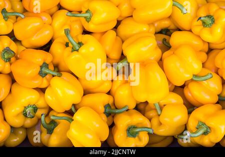 Yellow peppers for sale in the market at Kalamata, in the Peloponnese, Southern Greece. Stock Photo