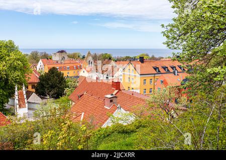 The ruins of St Clemens church (Sankt Clemens kyrkoruin) seen across the rooves of the medieval town of Visby on the island of Gotland in the Baltic S Stock Photo