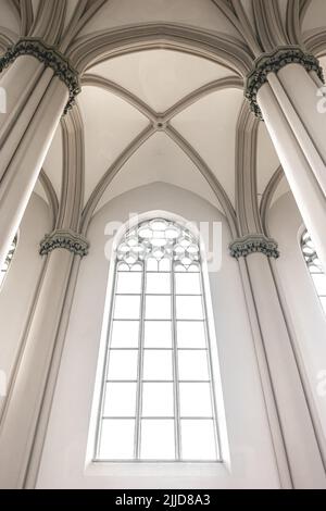 Bright interior of the church with stained-glass windows, view from below. Stock Photo