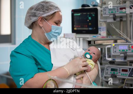 Nurse with a baby in intensive care. Newborn baby in the hospital. Stock Photo