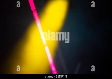 Yellow blurry smoke spot and pink bokeh streak. Stock Photo