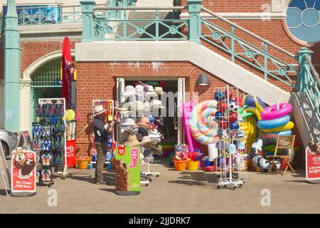 Beach front shop on the promenade at Brighto, East sussex, England. With man browsing. Stock Photo