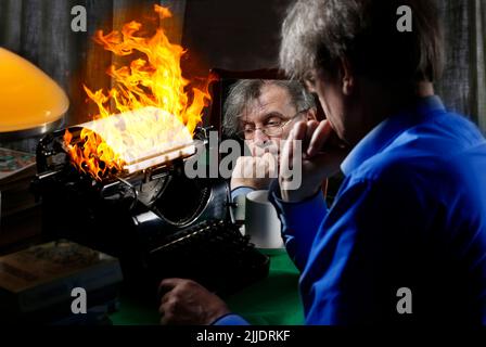 The author writes a book on fire on a printing press. Concept idea for writing a book, writing work, difficulties in writing text. Stock Photo
