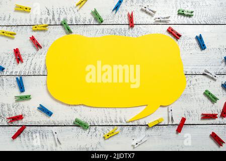 Colorful Pegs Placed Around Speech Bubble With Important Information. Stock Photo