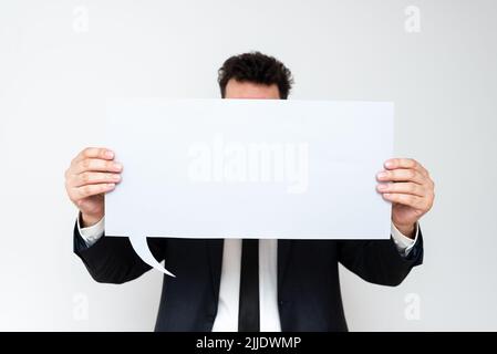 Businessman Holding Speech Bubble With Important Informations. Stock Photo