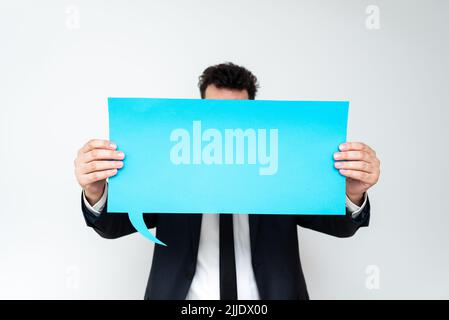 Businessman Holding Speech Bubble With Important Informations. Stock Photo