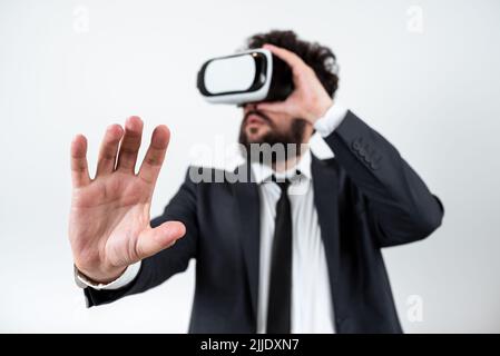 Man Wearing Vr Glasses And Presenting Important Messages With One Hand. Stock Photo
