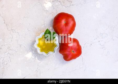 Spain extra virgin olive oil and three fresh tomatoes from garden. Stock Photo