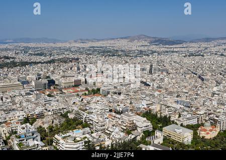 Athens, Greece - May 2022: Aerial landscape view of houses and buildings in the city stretching into the distance. Stock Photo