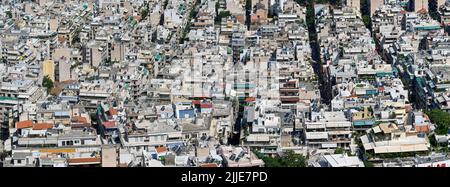 Athens, Greece - May 2022: Aerial panoramic view of homes and buildings packed tightly together in the city centre Stock Photo