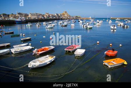 Barfleur, France. 11th June, 2022. View of the Port d'Échouage de Barfleur and the Eglise Saint-Nicolas in the background. The tidal difference leaves the boats dry at low tide. Credit: Hauke Schröder/dpa-Zentralbild/dpa/Alamy Live News Stock Photo