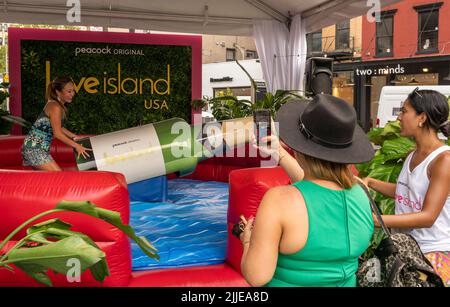 Visitors brave the excessive heat to flock to Peacock’s “Love Island: USA” brand activation in the Meatpacking District of New York on Wednesday, July, 20, 2022. Originally developed in the UK, the “reality” dating series is in its fourth season and premiered on the streaming network on July 19. (© Richard B. Levine) Stock Photo