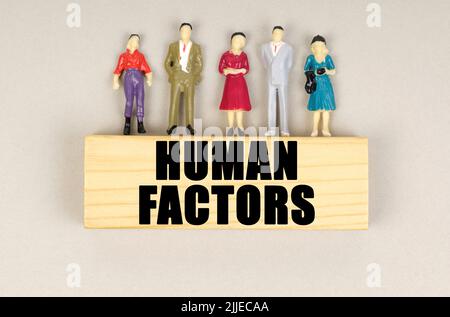 Business concept. On the block with the inscription - Human Factors, there are miniature figures of people. Stock Photo