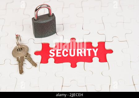 Business and security concept. On puzzles there is a lock and keys, on a red surface there is an inscription - security Stock Photo